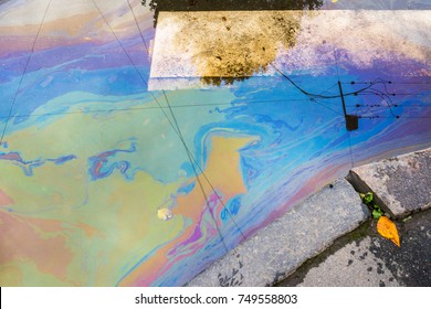 Background or texture of an oil spill on asphalt road