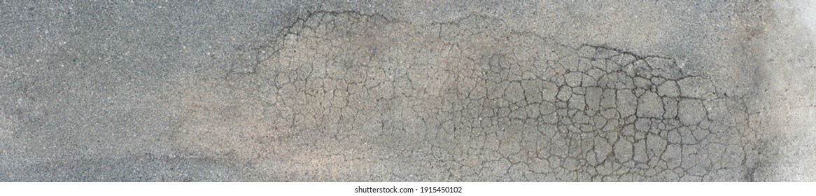 Background texture of old cracked asphalt pavement. - Shutterstock ID 1915450102