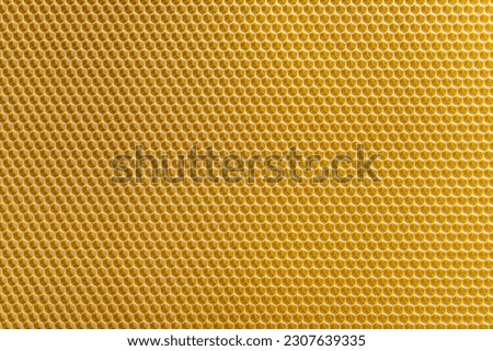 Background texture and pattern of section voshchina of wax honeycomb from a bee hive for filled with honey. Voshchina an artificial basis for the construction of honeycombs, sheet of wax of the cells