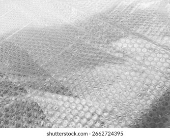 Background texture of plastic bubble wrap used for packing and protecting products from bumps and scratches.