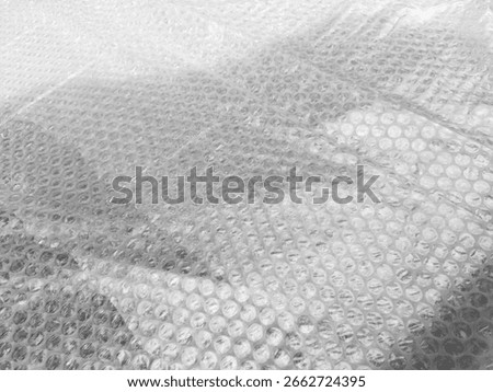 Background texture of plastic bubble wrap used for packing and protecting products from bumps and scratches.