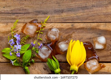 Background Texture Purple Flower ,yellow Flower Ylang Ylang And Iced Water Arrangement Flat Lay Postcard Style On Wooden