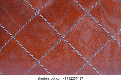 Background, Texture. Red Leather Stitched With White Threads. Quality Leather With Decorative Stitching. High Quality Photo