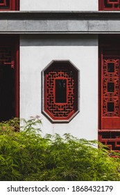 Background Texture Of Red Octagonal Window On White Wall Of Traditional House