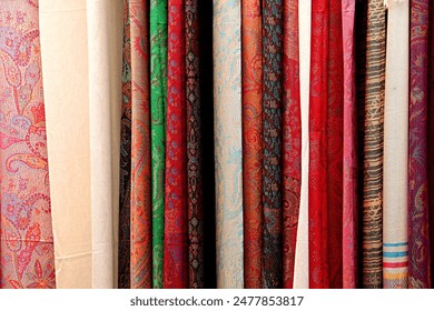 Background, texture samples of silk scarves in a textile shop