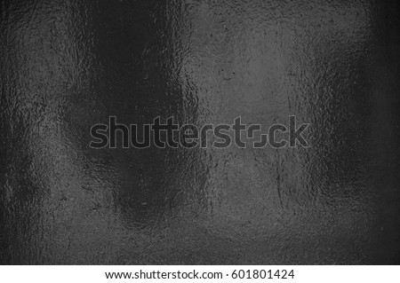 Background texture of shiny black grey foil