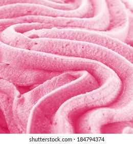 Background texture of swirling pink Italian ice cream with a ridged pattern in square format