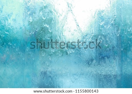 Background texture of water falling on the glass