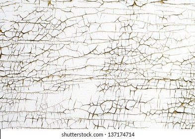 Background texture of white cracked paint on wooden surface.