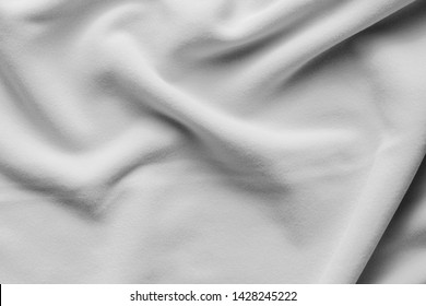 Background Texture Of White Fleece Sheet, Soft Napped Insulating Fabric Made Of Polyester, Wavy Pattern, Top View