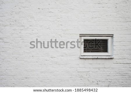 Background texture of whitte brick wall with small window