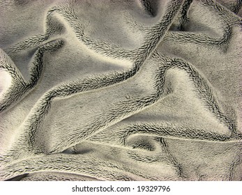 Background texture of wrinkled shiny black fur coat fabric