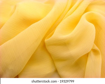 Background texture of wrinkled shiny yellow fabric