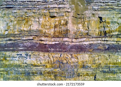 Background of textured layers of earth, sedimentary minerals and stones. Mining underground geological strata rock or sand for geology studies. Closeup of remote layered stone detail with copyspace - Shutterstock ID 2172173559
