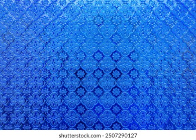 Background of Thai pattern translucent glass. Thai style decorative translucent glass. Blue vintage thai stained glass.