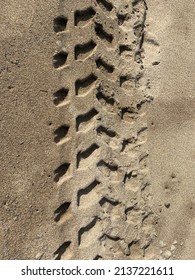 Background of tire track on the beach sand with  full frame format and natural daylight. This image sutable for natural background and texture vertical format