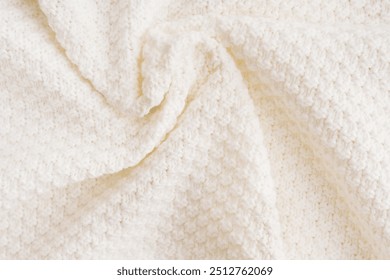 Background of top view of soft warm textile texture with swirl of waves of casual sweater of cardigan cloth knitted from wool or merino yarn of beige white colour used as comfortable winter fabric - Powered by Shutterstock