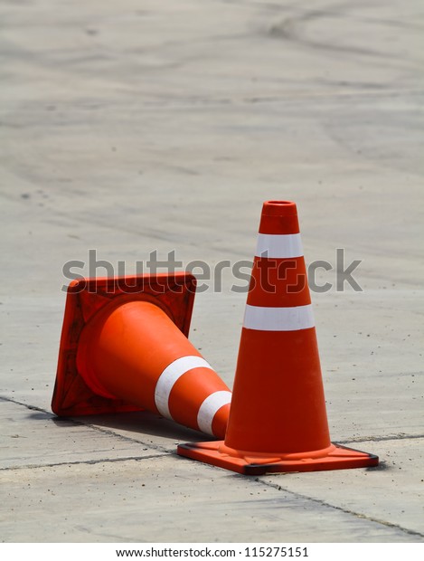 Background with traffic\
cone on road track