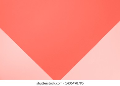 Background in trendy coral color. Fashionable pink and ornage paper. Top view. Minimal concept. Trendy coral color of year 2019