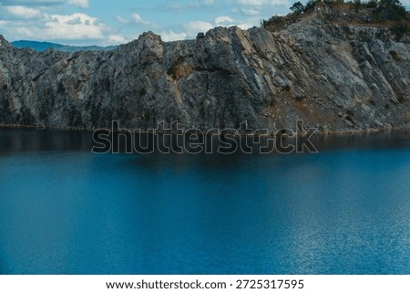 Background A turquoise river surrounded by natural rock walls beautiful scenery cloudy sky monstrous mountains Khon Kaen Thailand