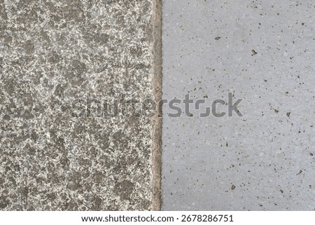 A background of two concrete textures side-by-side: one rough and speckled, one smooth and gray, divided by a clean vertical line