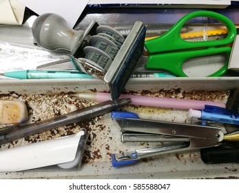 Background Of Used Messy Spoil Stationary Pen Scissors Stamp Eraser Liquid Paper Ruler Mechanical Pencil Placed In Dirty Rusty Metal Twin Drawer In Office Desk