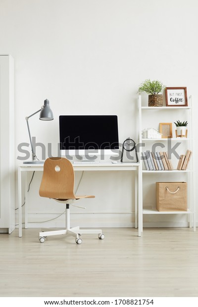 Background Vertical background image of minimal\
home office interior with wooden chair and white computer desk\
against white wall, copy\
space
