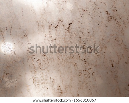 the background of a very dirty glass through which the sunlight barely breaks through. soft effect