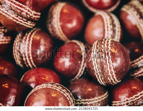 A background of\
vintage red leather cricket balls with white stitching. Retro style\
processing. 