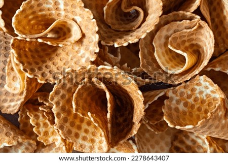 Background of waffle cones, delicious confectionery pastry, waffle cone for ice cream, top view.