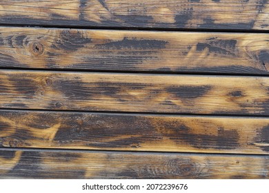 Background - wall made of burnt and brushed wooden planks