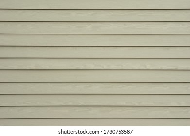 A Background Wall Of Tan Shiplap Siding.