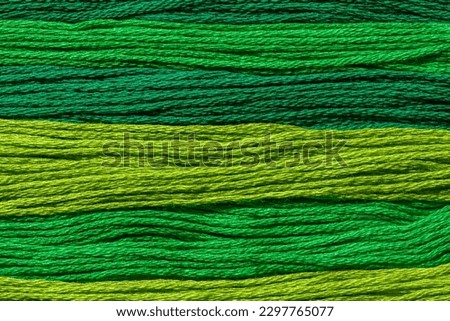 Background wallpaper for text.  Texture of green threads of different shades arranged in parallel.  Different shades of green