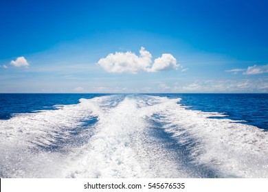 Background water surface behind of fast moving motor boat. Vacation recreation holiday travel adventure concept.
