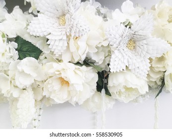 Background of white artificial flowers. Close up