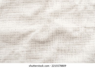 Background Of White Linen Fabric. Texture Of White Material With Folds