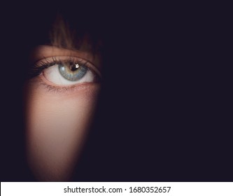 Background With Woman's Eye Emerging From The Shadows