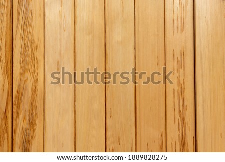 Background. Wood. 8 planks placed vertically with a yellowish color.