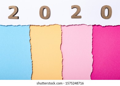 Background With Wooden Figures Of The Date 2020 On Multicolored Cardboard Stripes, New Year Concept, School Calendar Cover Design