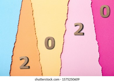 Background With Wooden Figures Of The Date 2020 On Multicolored Cardboard Stripes, New Year Concept, School Calendar Cover Design