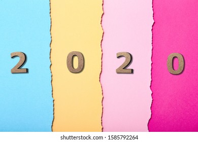 Background With Wooden Figures Of The Date 2020 On Multicolored Cardboard Stripes, New Year Concept, School Calendar Cover Design