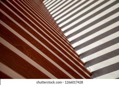 Background of wooden planks arranged diagonally, Diagonal boards with light incidence. Format-filling view of diagonally arranged wooden planks with uniform gaps and rear light incidence 