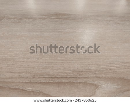 Background of wooden table with cream paint with reflection of lights from above.  Soft Focus.