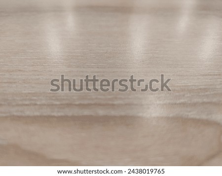 Background of wooden table with cream paint with reflection of lights from above.  Soft Focus.