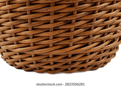 In the background — a woven pattern. A woven basket made of artificial rattan. Against a white background. A flat pattern. The weaving is done using the “braid” technique.