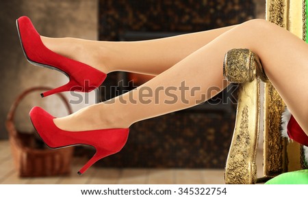 background of xmas fireplace and slim woman legs 