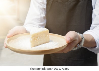 Background Of Young Handsome Waiter Serving Organic Homemade Delicious Low Fat Cheese Cake In Cafe. Blank Area For Empty Copy Space