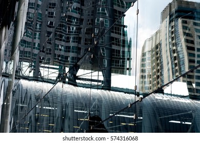 Backgrounds Of Modern Architecture With Windows Glass Reflection Of City.