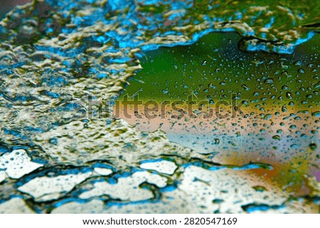 Backgrounds and Textures. Soap and Water splash and spread upon a glass window. Water on glass. Wet Background. Liquid Dreams. Water washes away dirt. Car Wash. Wet Window. Bubble Bath. Water on glass.
