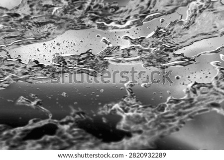 Backgrounds and Textures. Soap and Water splash and spread upon a glass window. Water on glass. Wet Background. Liquid Dreams. Water washes away dirt. Car Wash. Wet Window. Bubble Bath. Water on glass